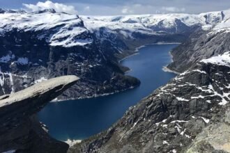 The top of the famous Trolltunga cliff overlooking Lake Ringedalsvatnet in Norway.