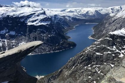 The top of the famous Trolltunga cliff overlooking Lake Ringedalsvatnet in Norway.