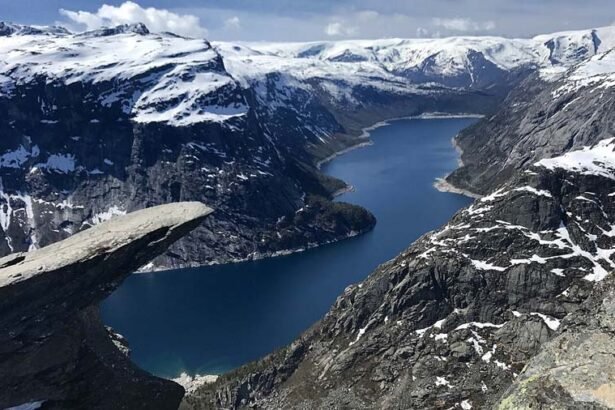 The top of the famous Trolltunga cliff overlooking Lake Ringedalsvatnet in Norway.