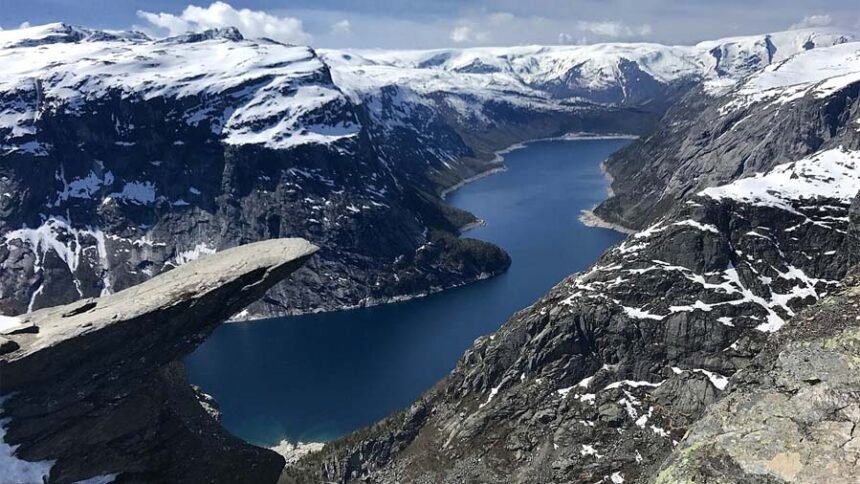 The top of the famous Trolltunga cliff overlooking Lake Ringedalsvatnet in Norway.