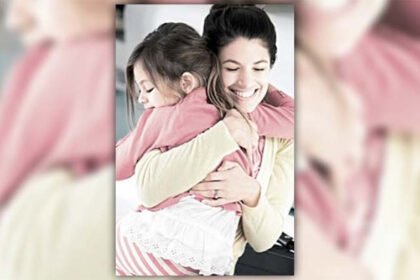 A loving parent hugs a young child before bedtime in a cozy bedroom environment, with dim lighting and no screens.