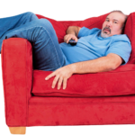 A modern corporate office worker sitting at a desk with conceptual health risk graphics representing sedentary behavior risks