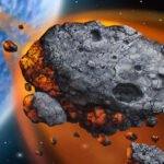 A dark fusion-crusted meteorite specimen displayed on a white laboratory surface under scientific lighting.